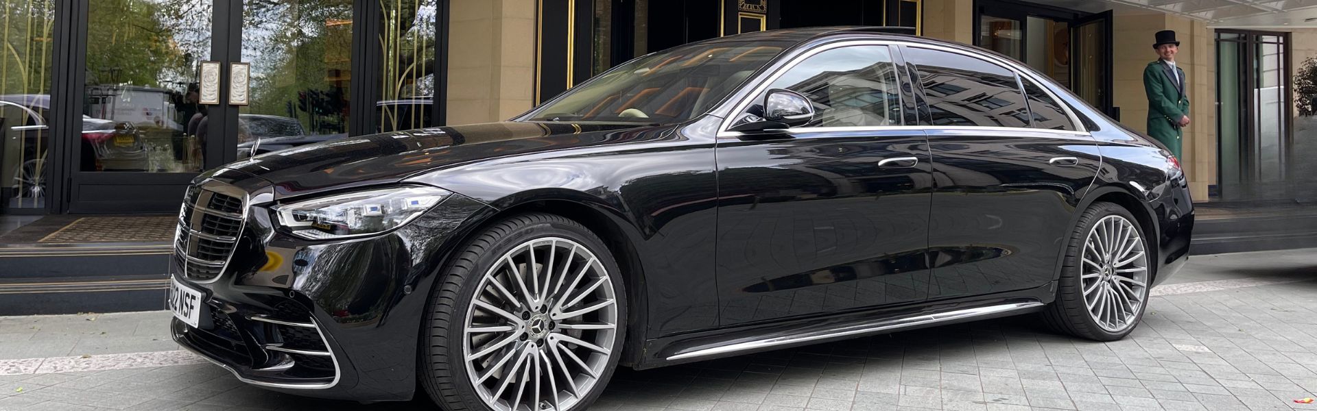 Mercedes S Class chauffeur outside hotel