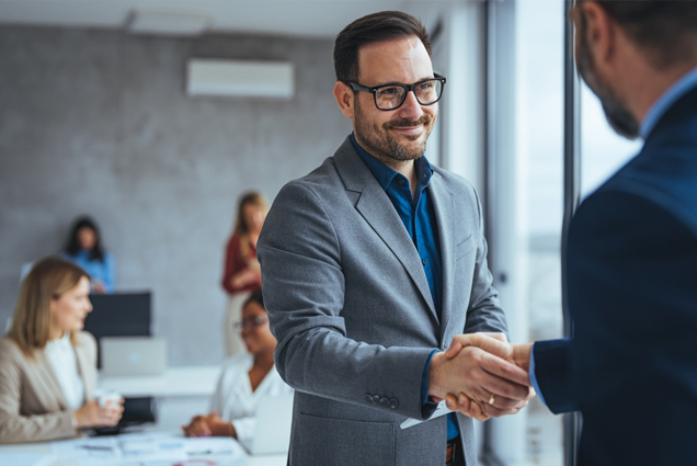 Business professionals shaking hands in a meeting