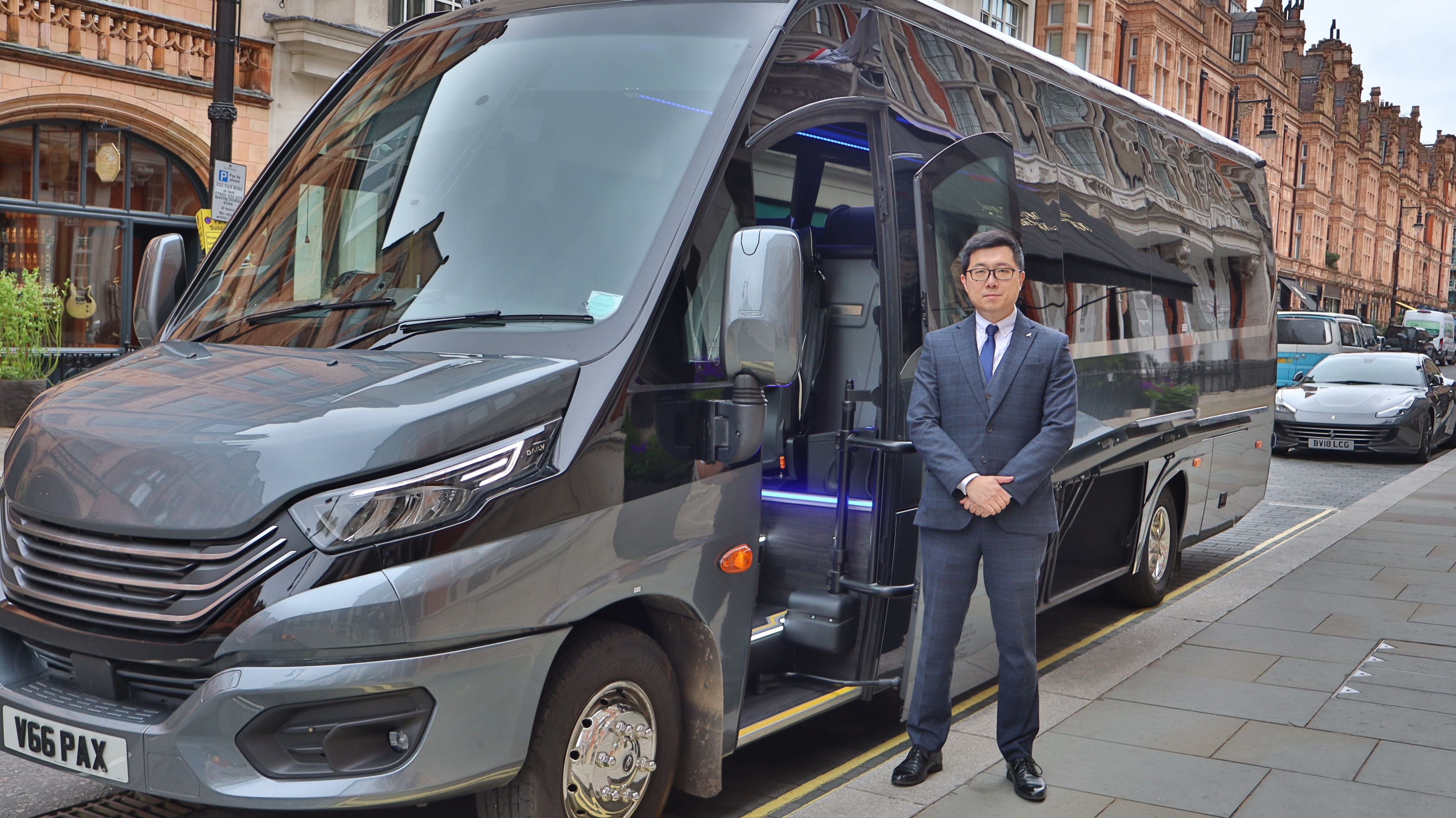 Professional Imperial Ride Chauffeur Standing Beside Mercedes Executive Minibus